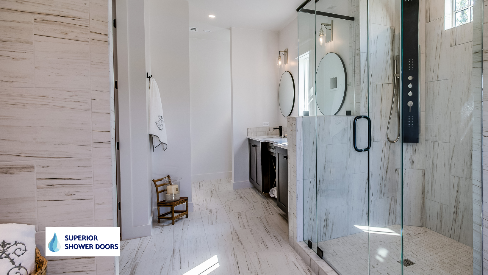 A bathroom with a walk in shower and a sink. Custom semi frameless door.