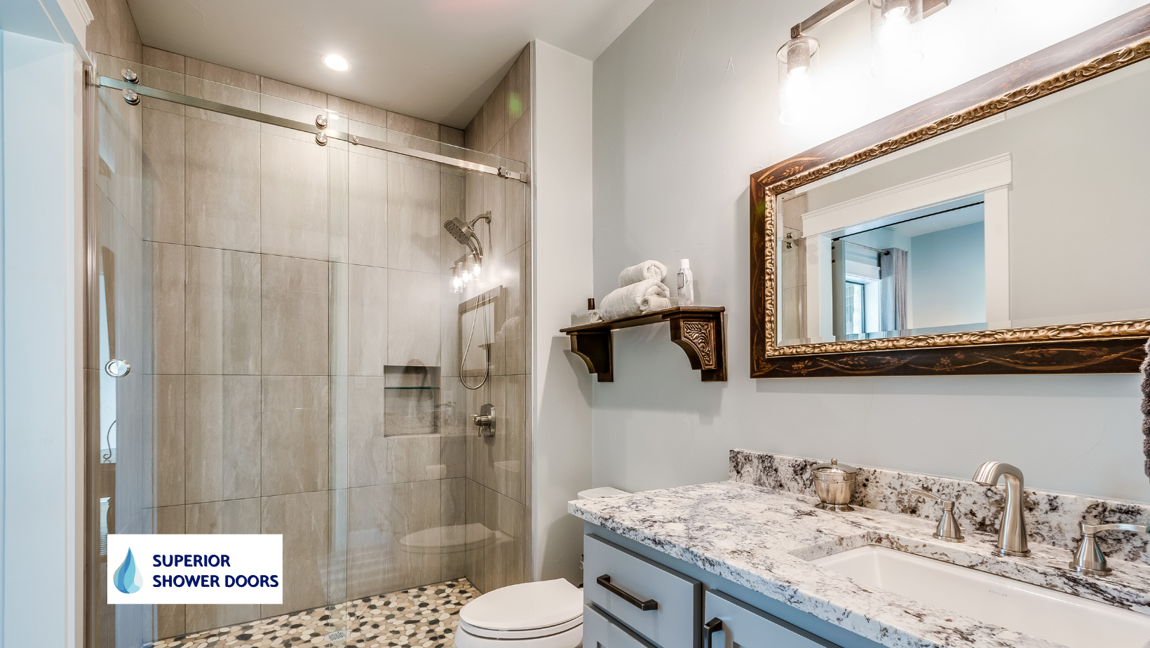 A bathroom with a walk in shower , sink , mirror and toilet.