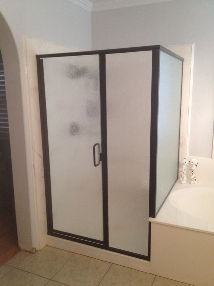 A bathroom with a walk in shower and a bathtub