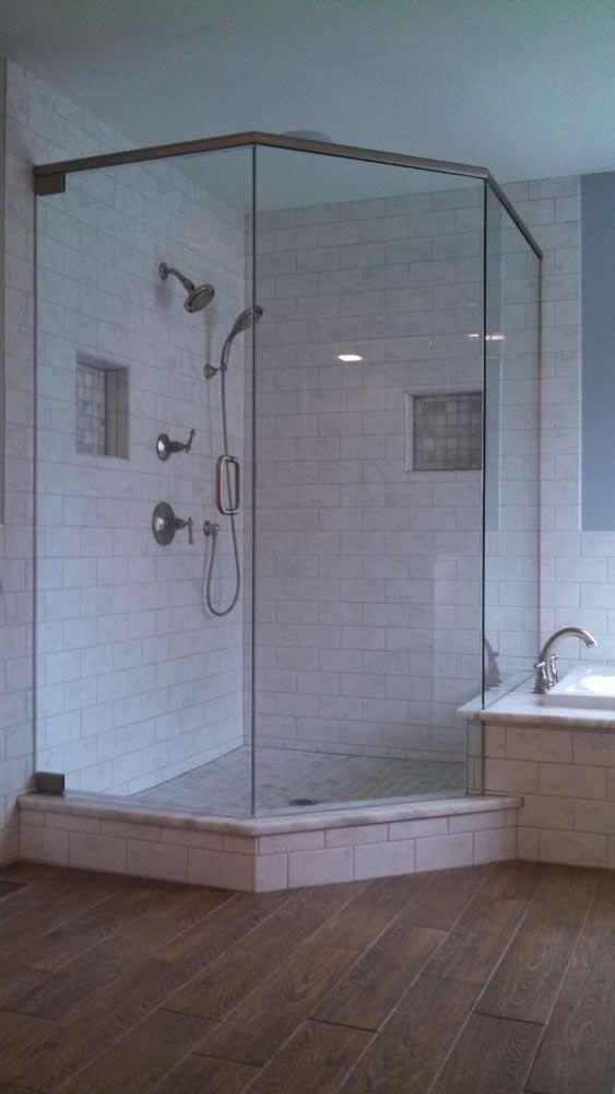 A bathroom with a walk in shower and a bathtub.