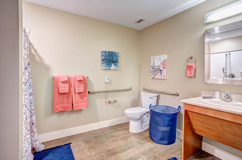 A bathroom with a toilet , sink , and shower.