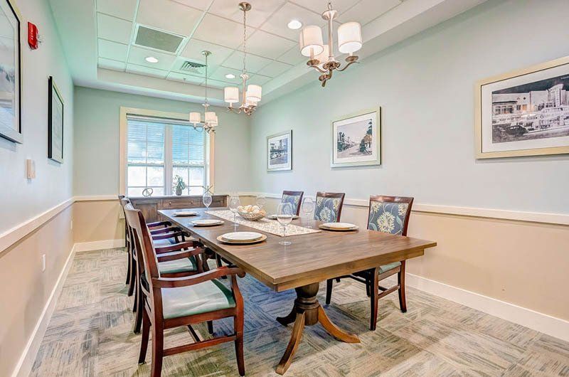 There is a long table and chairs in the room.