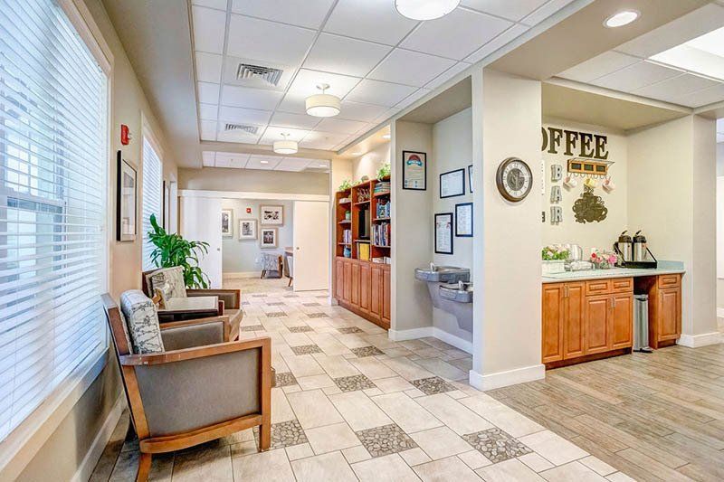 A long hallway with chairs and a coffee bar in a building.