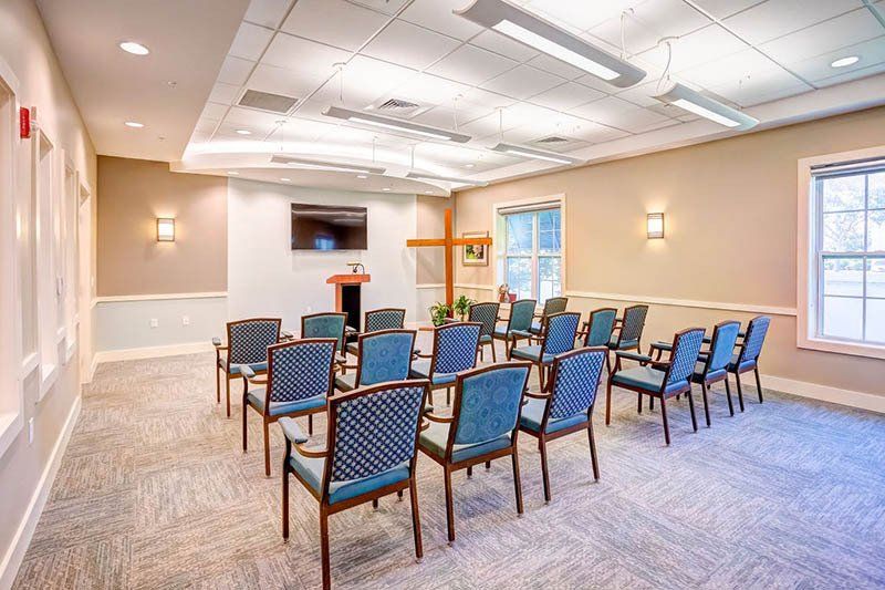 A room with rows of chairs and a podium in it.