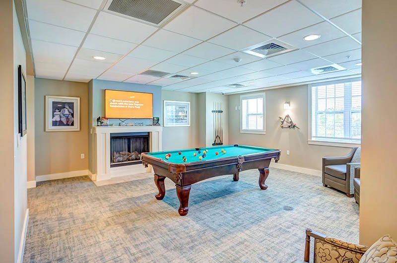 There is a pool table in the middle of the room.