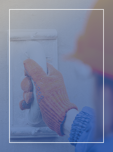 a person wearing gloves and a hard hat is working on a light switch .