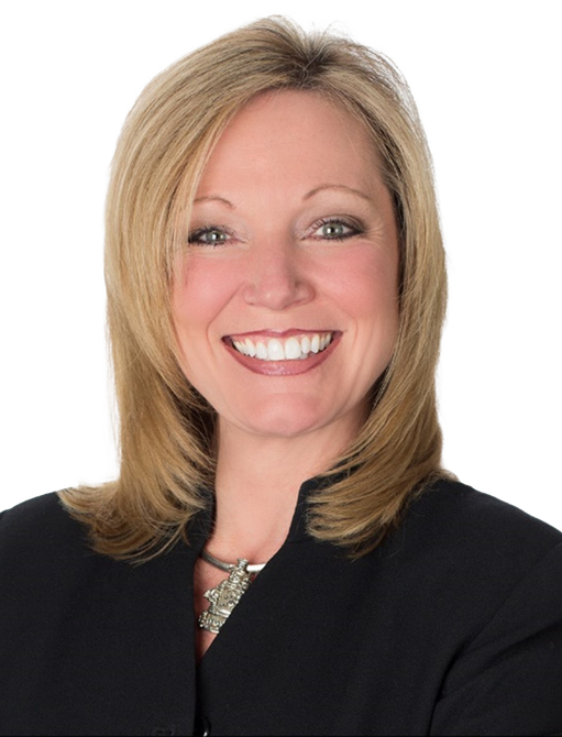 A woman in a black jacket is smiling for the camera A woman in a black jacket is smiling for the camera