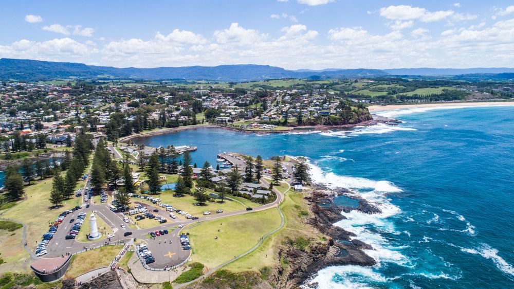 An Aerial View Of Kiama Next To A Body Of Water — Sattin's Metal Roofing In Kiama, NSW