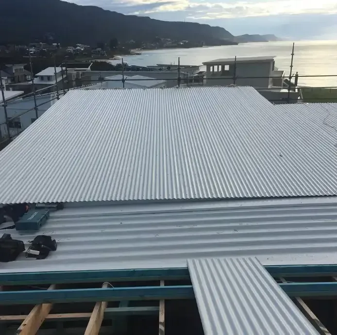 A Roof With A Body Of Water And Mountains In The Background — Sattin's Metal Roofing In Avondale, NSW