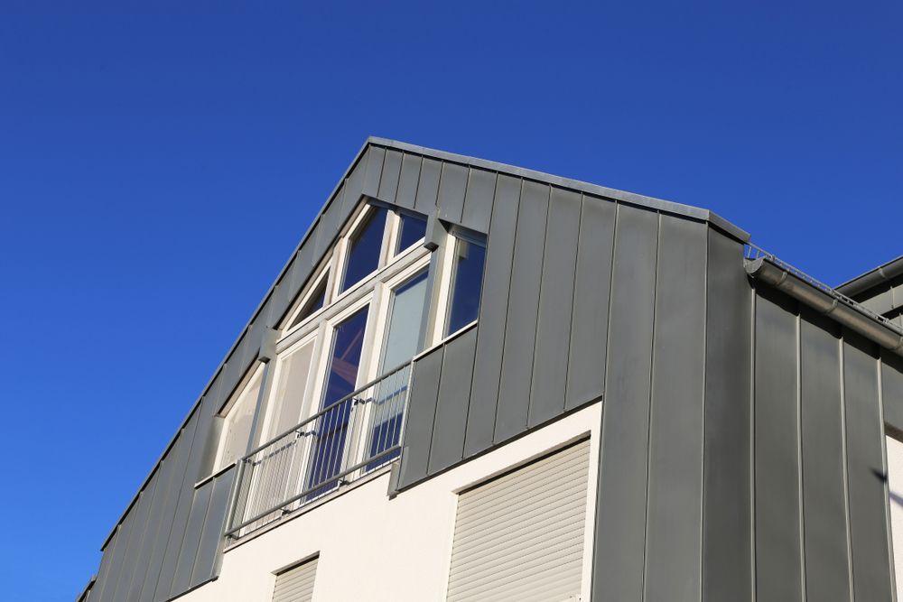 A Building With A Balcony And A Blue Sky In The Background — Sattin's Metal Roofing In Avondale, NSW
