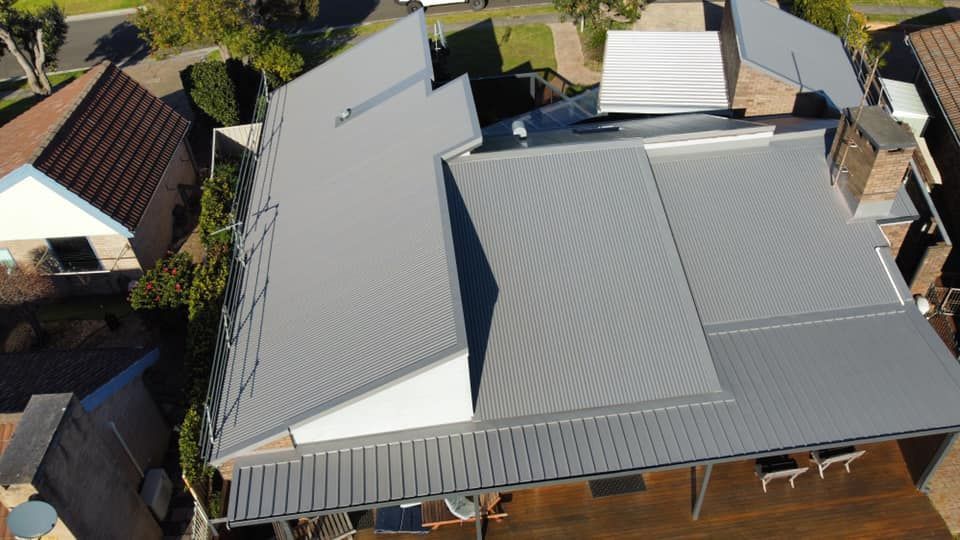 An Aerial View Of A House With A Grey Roof — Sattin's Metal Roofing In Avondale, NSW