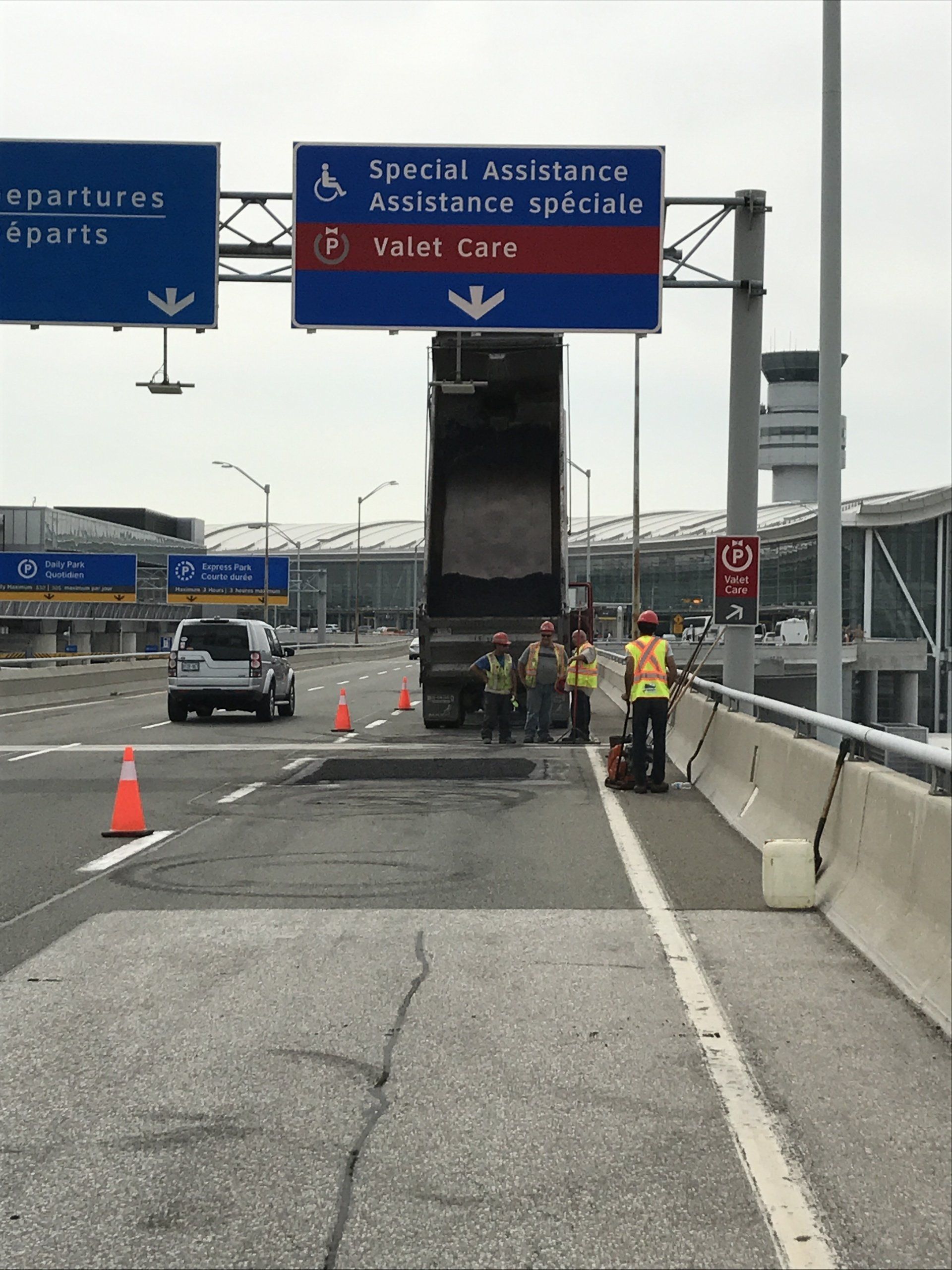A truck is driving down a highway under a sign that says spatial maintenance