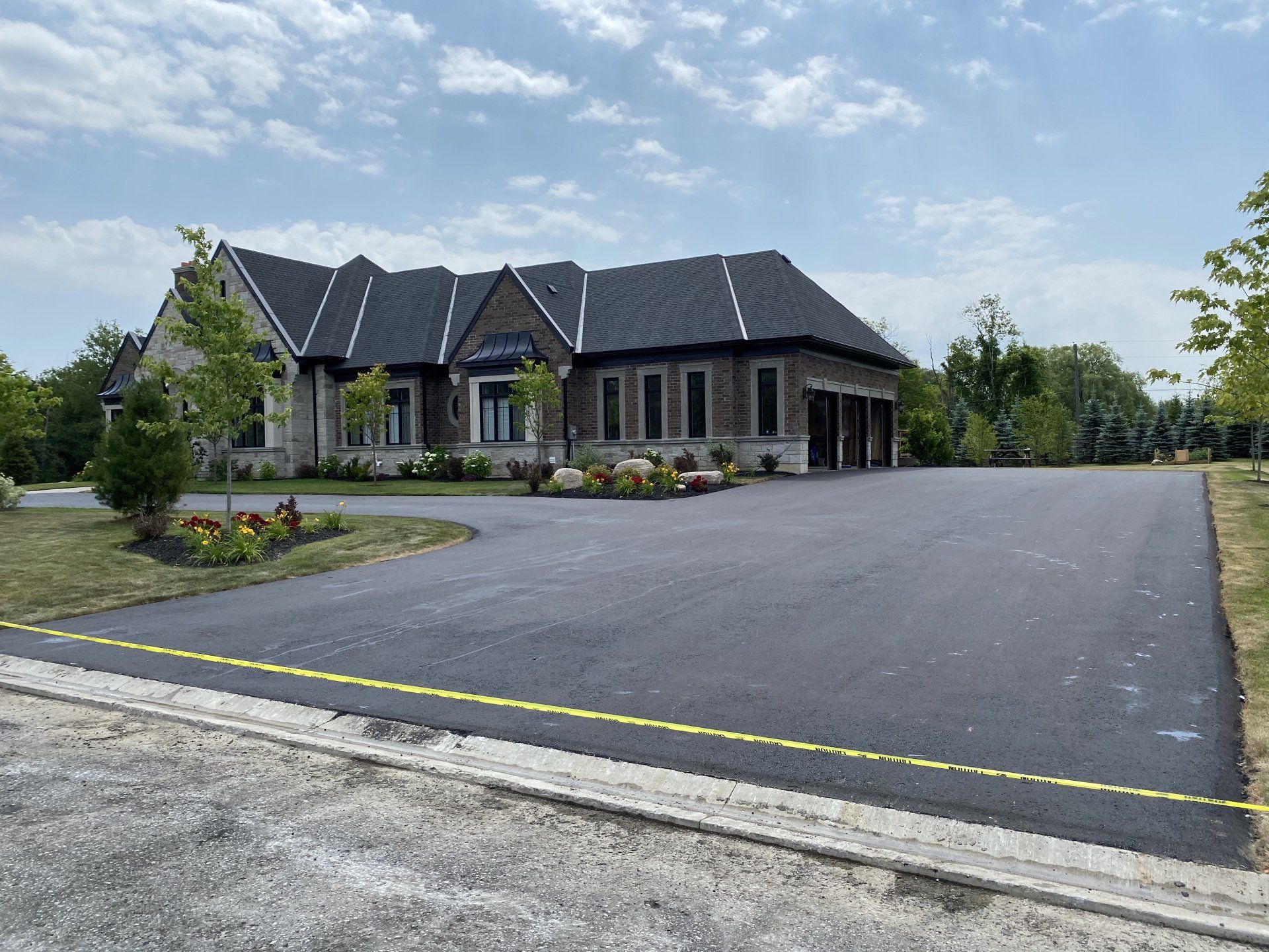 A large house with a large driveway in front of it.