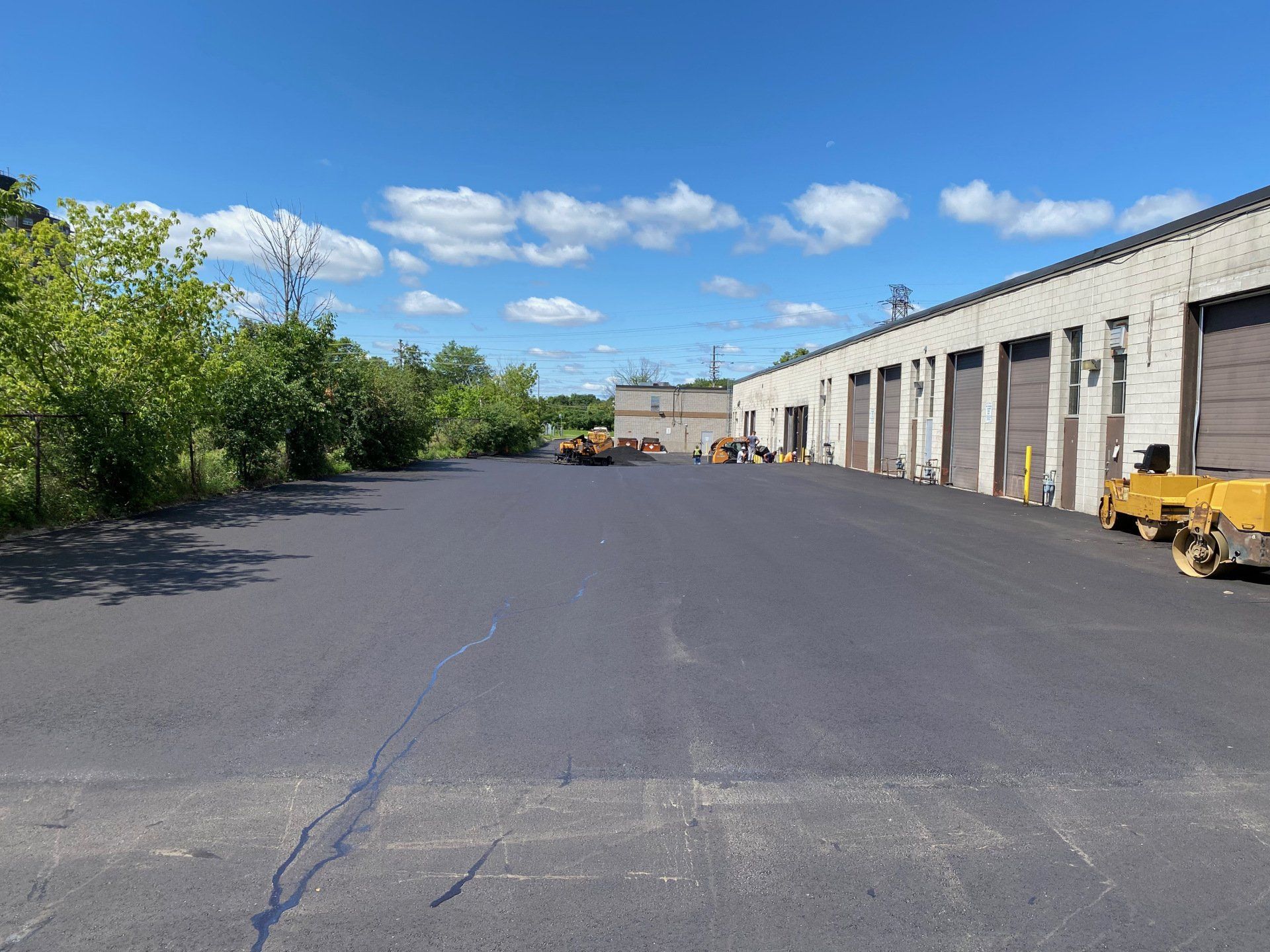 A large parking lot with a building in the background.