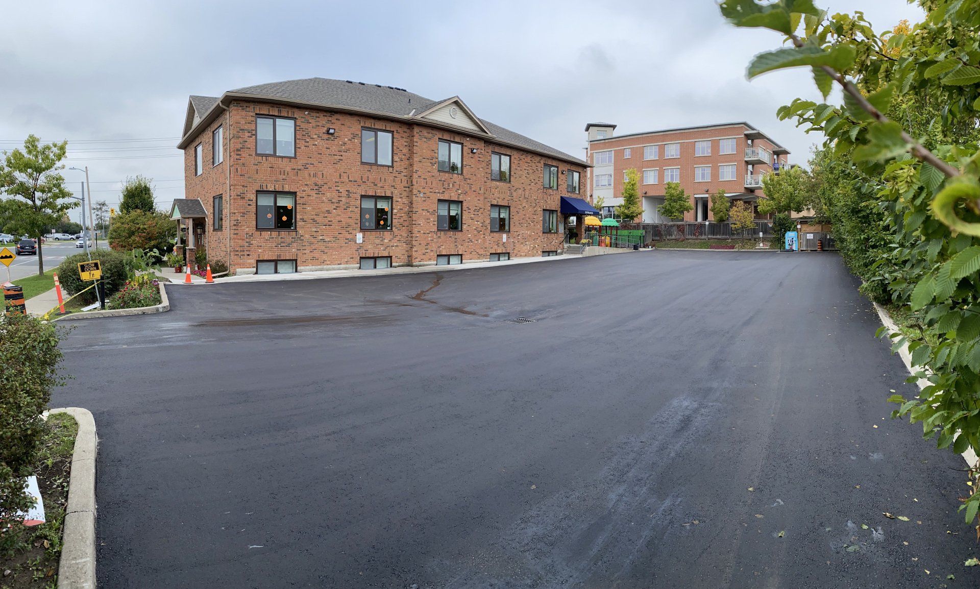 A large brick building with a parking lot in front of it