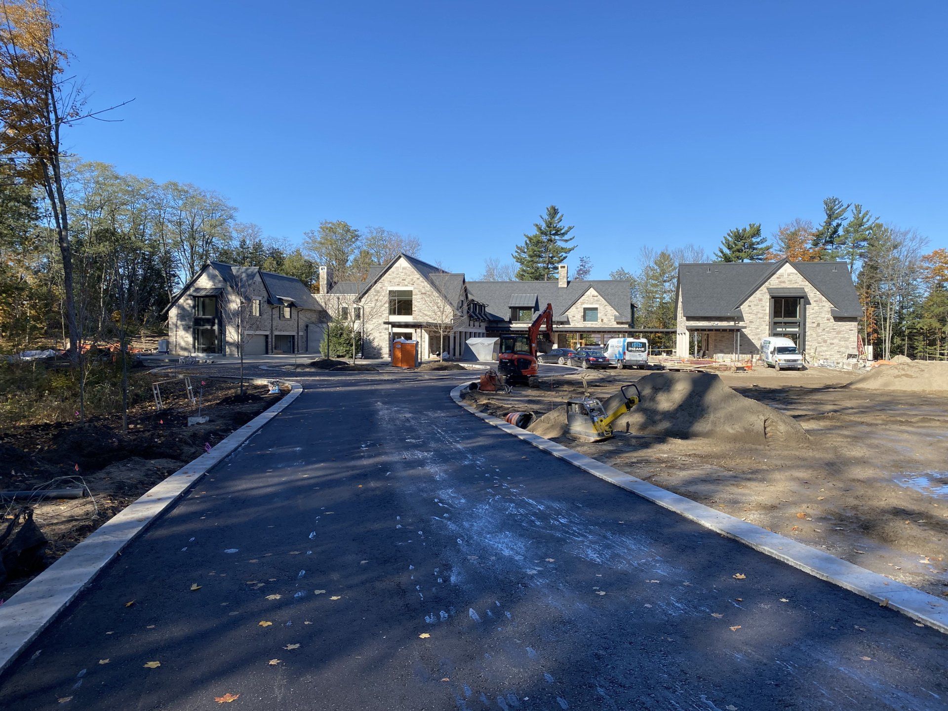 A row of houses are being built in a residential area.