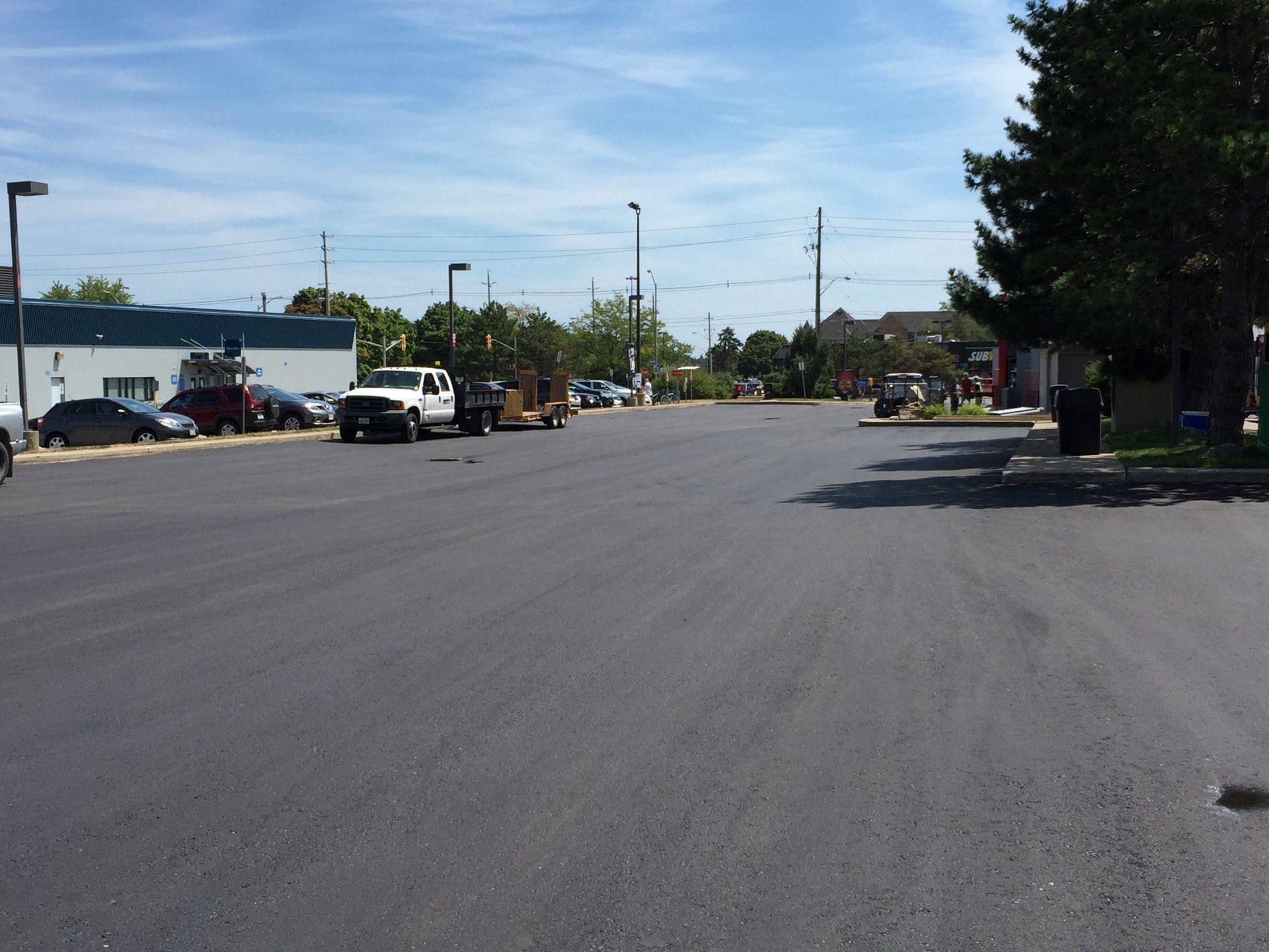 A lot of cars are parked on the side of the road