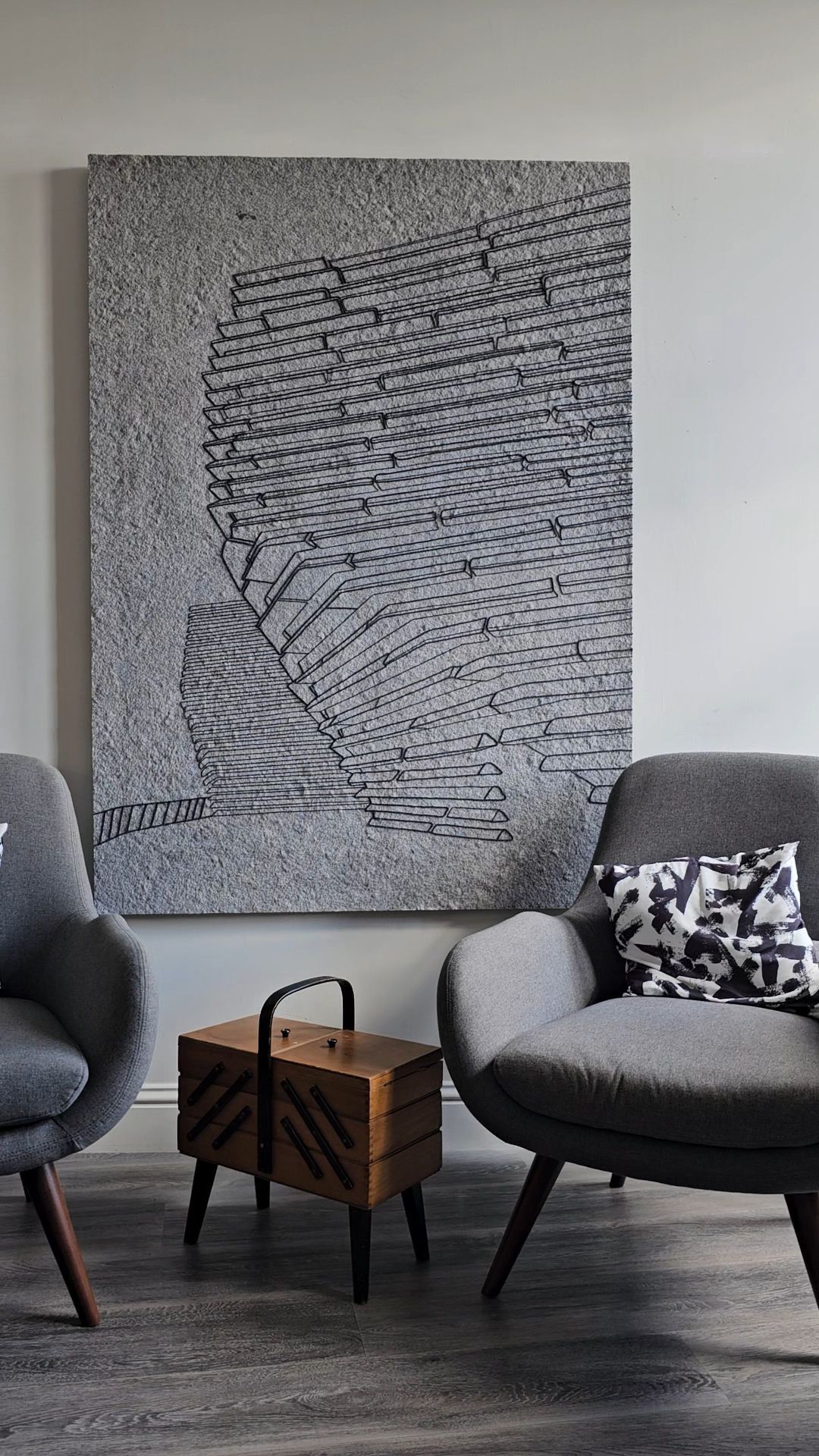Textured wall art panel made from recycled textile waste with intricate black line design