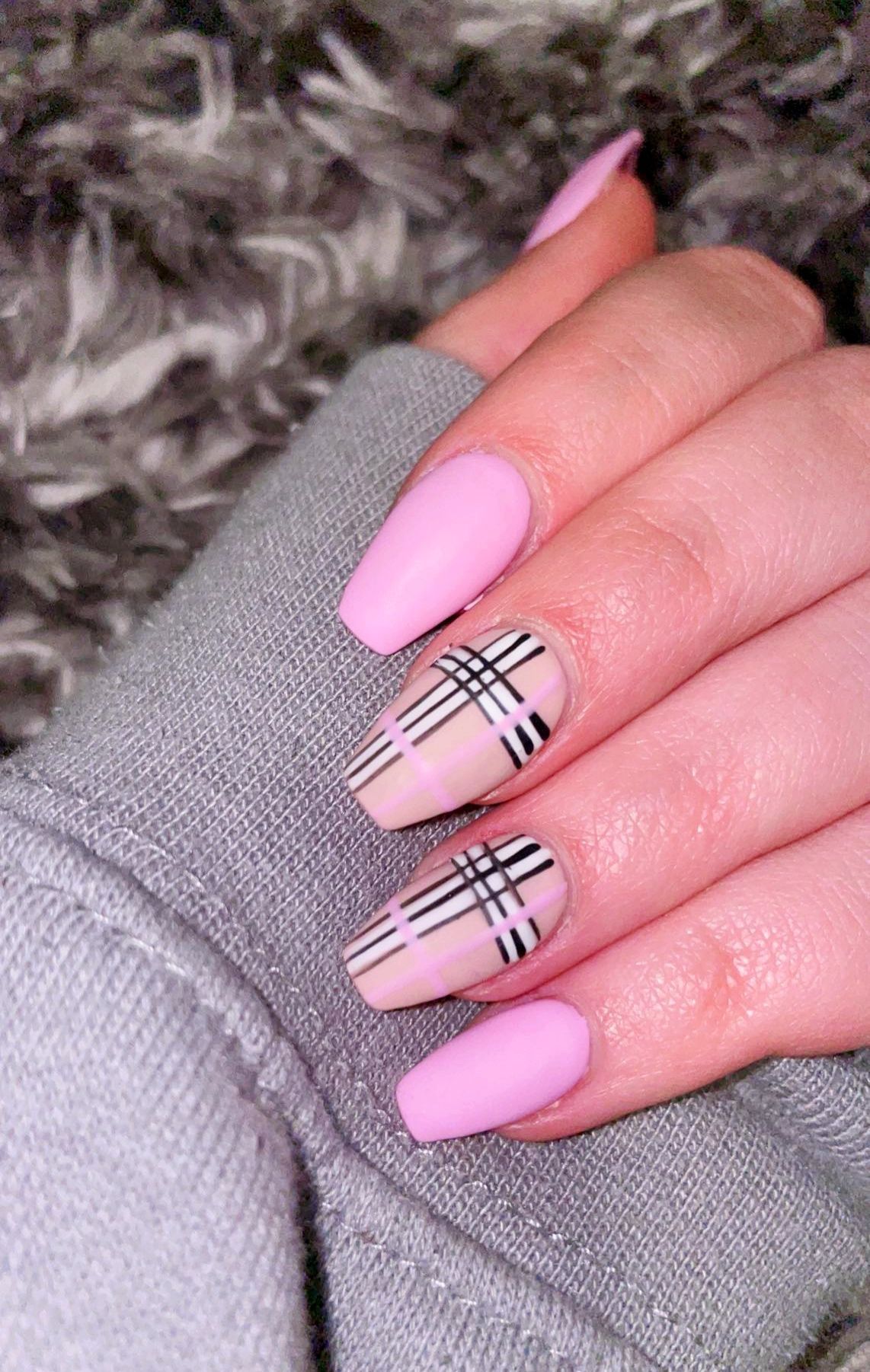 a close up of a person 's nails with a plaid design on them .