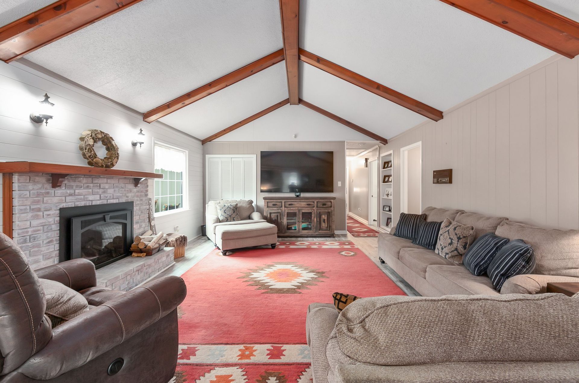 A living room with a couch , chairs and a coffee table