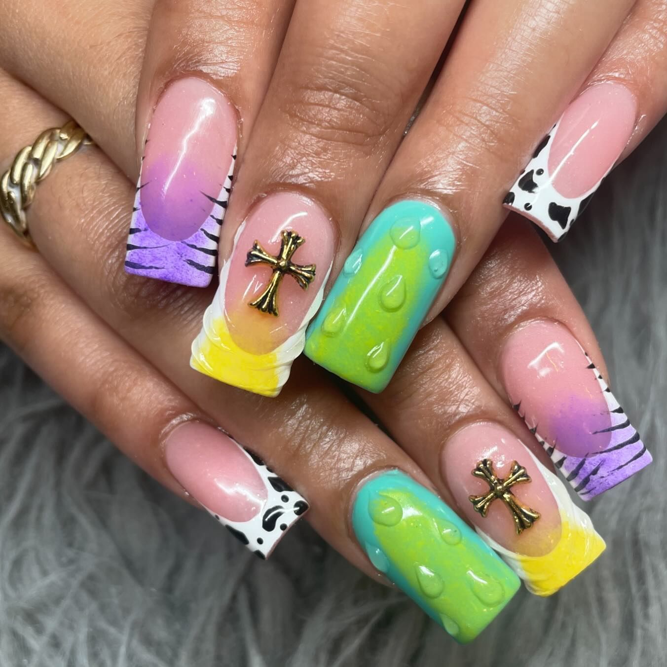 A close up of a woman 's nails with a cross on them