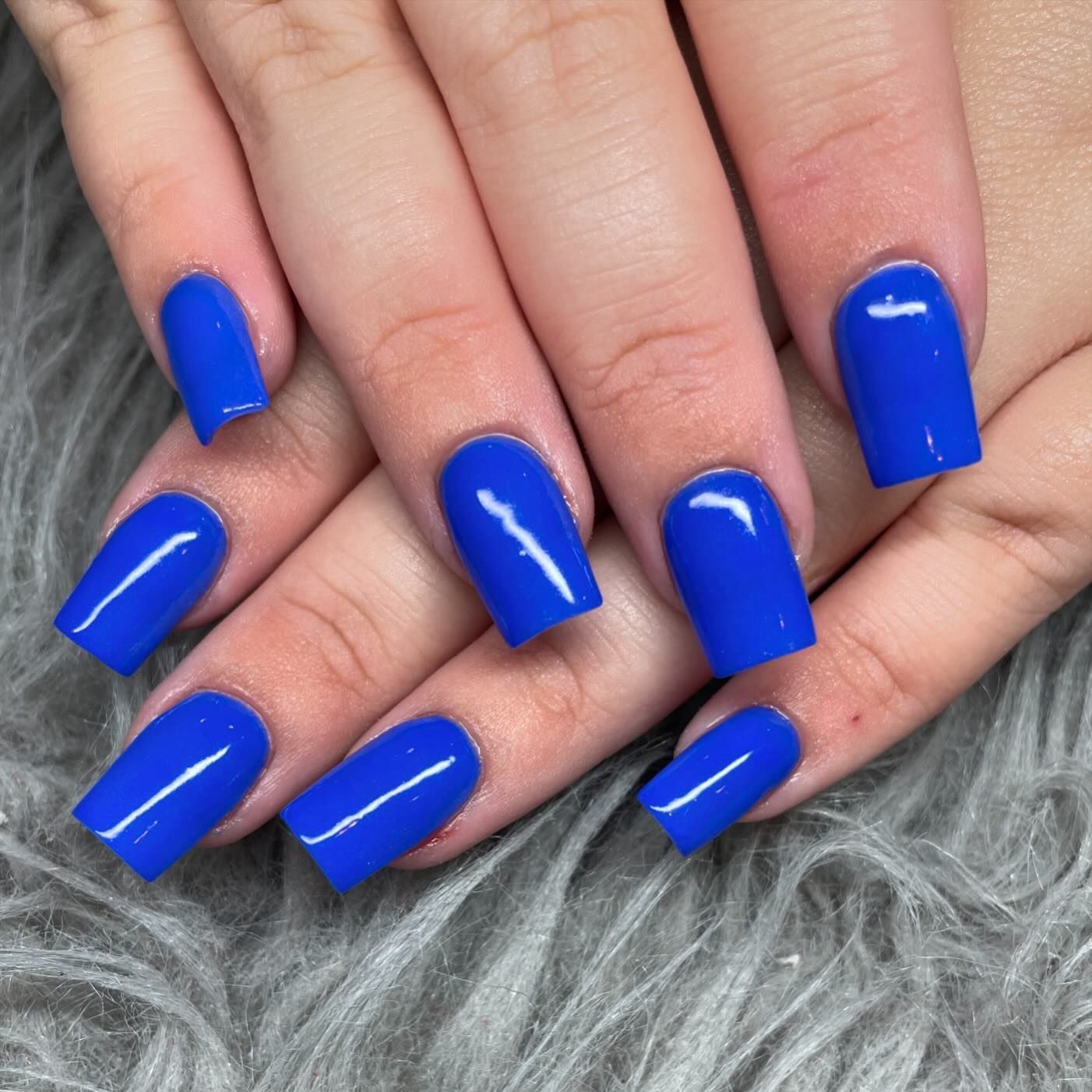 A close up of a woman 's blue nails