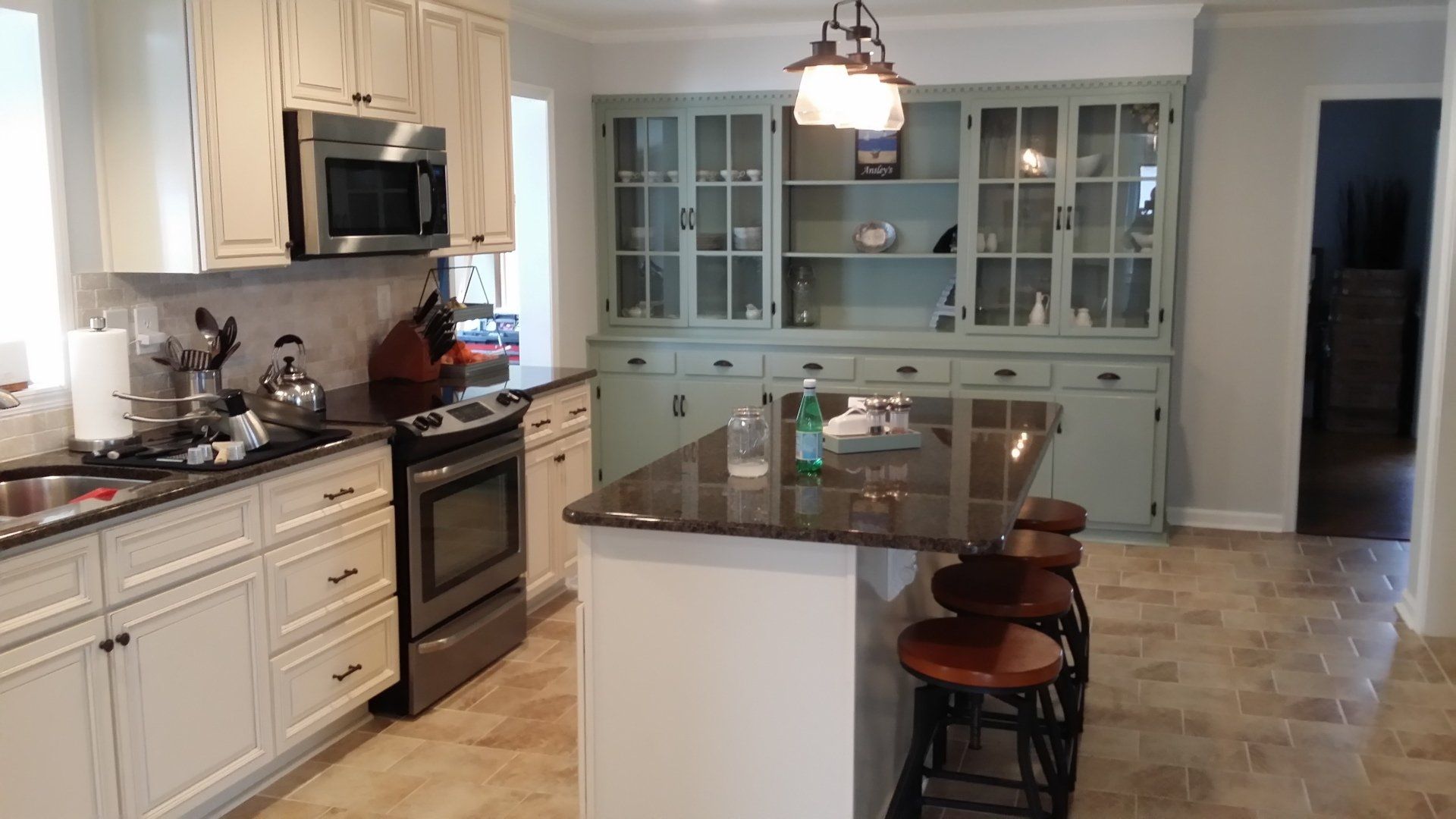 Kitchen with gray glass-front cabinets