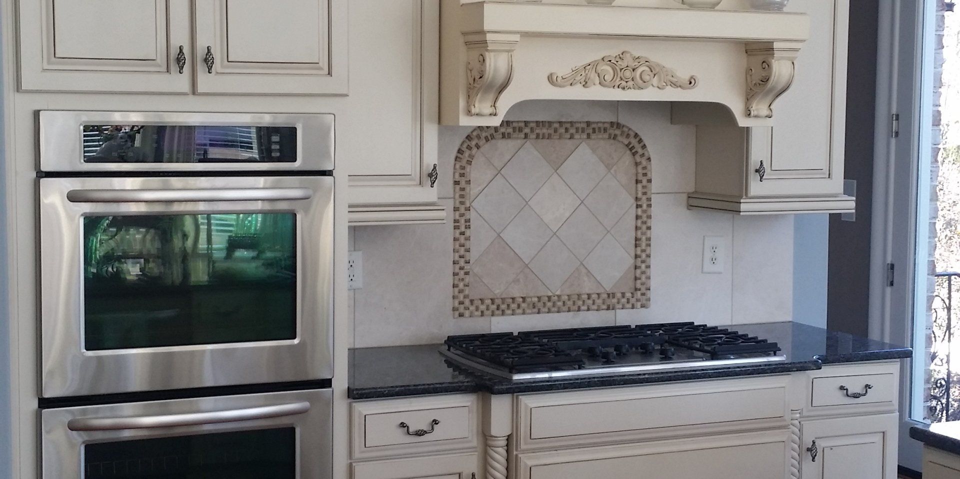 White kitchen with custom vent hood