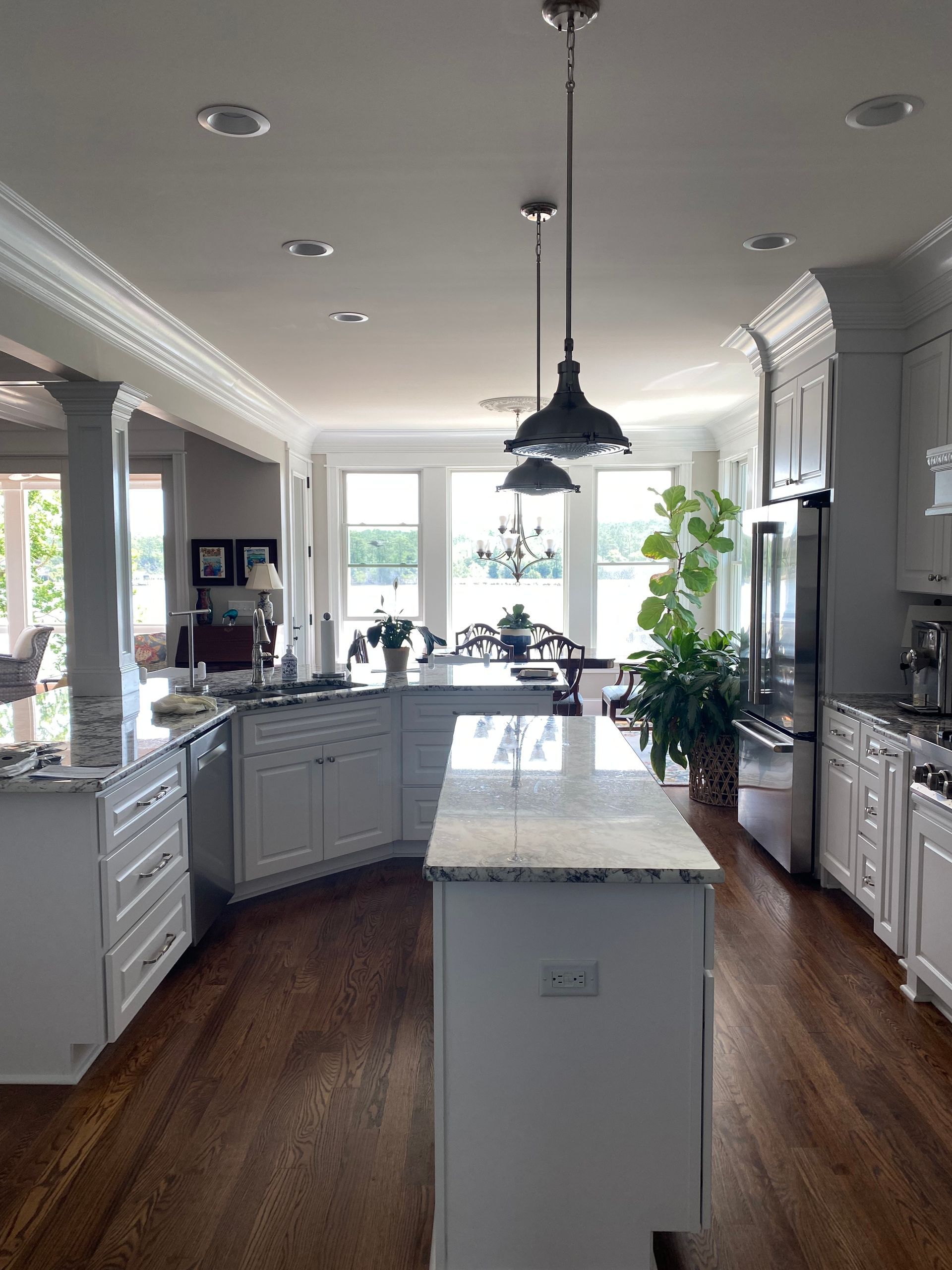 white kitchen with a water view