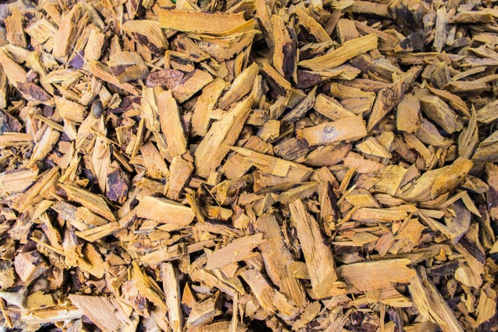 A Pile of Wood Chips is Sitting on a Table — Dingo's Tree Services In Shellharbour, NSW