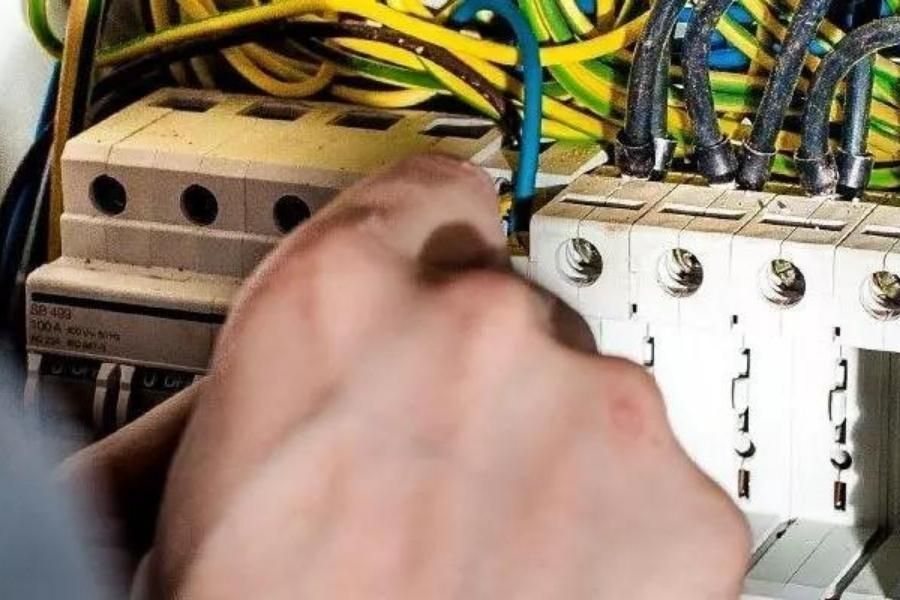 An electrician on a roof expertly installing a security camera to enhance home security.