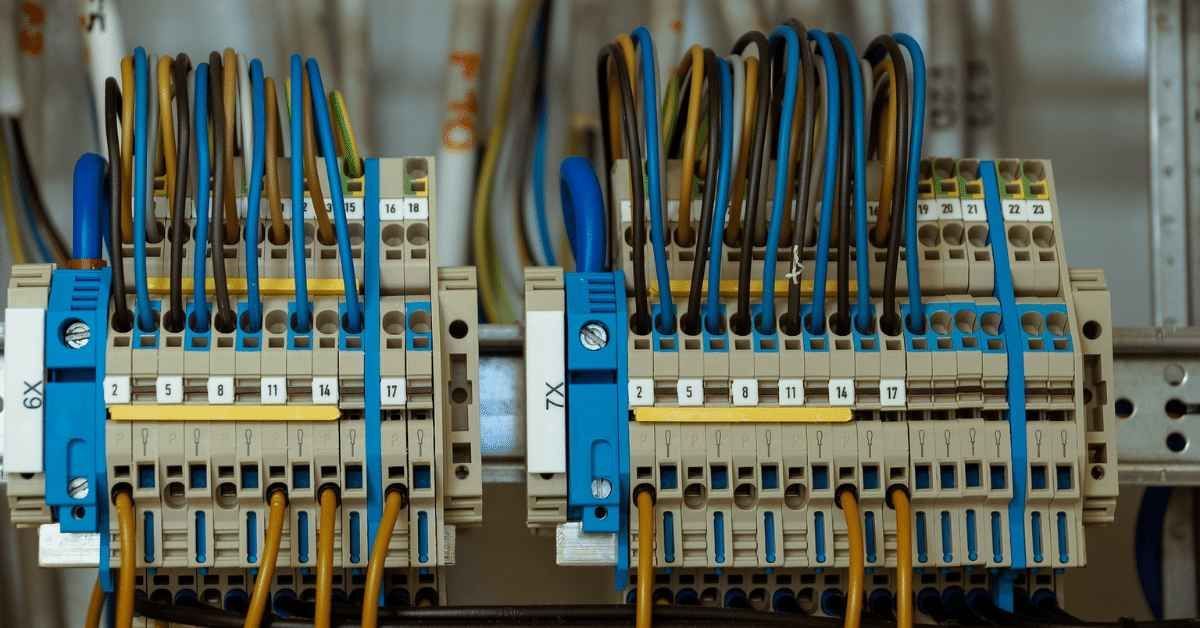 Electrician mounting a security camera on the ceiling for enhanced safety and surveillance.
