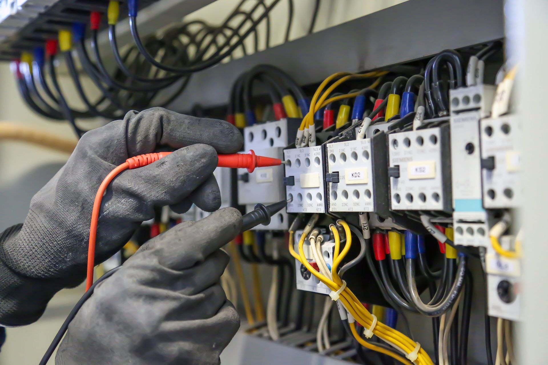 An electrician on a roof expertly installing a security camera to enhance home security.