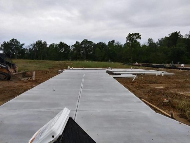 a concrete walkway is being built in a field