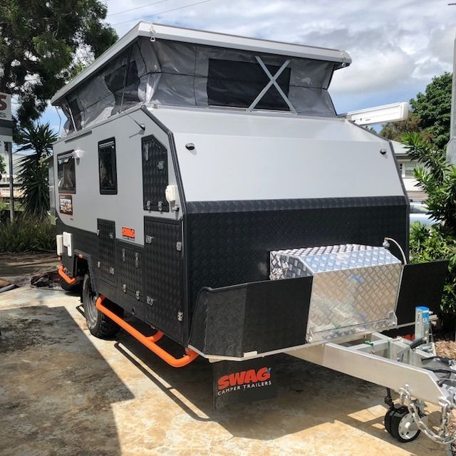 A Swag Trailer Is Parked In A Parking Lot — Perkins Caravans in Ballina, NSW