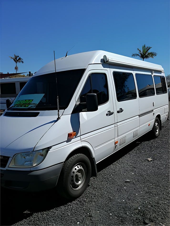 A White Motorhome Is Parked In A Gravel Lot — Perkins Caravans in Grafton, NSW