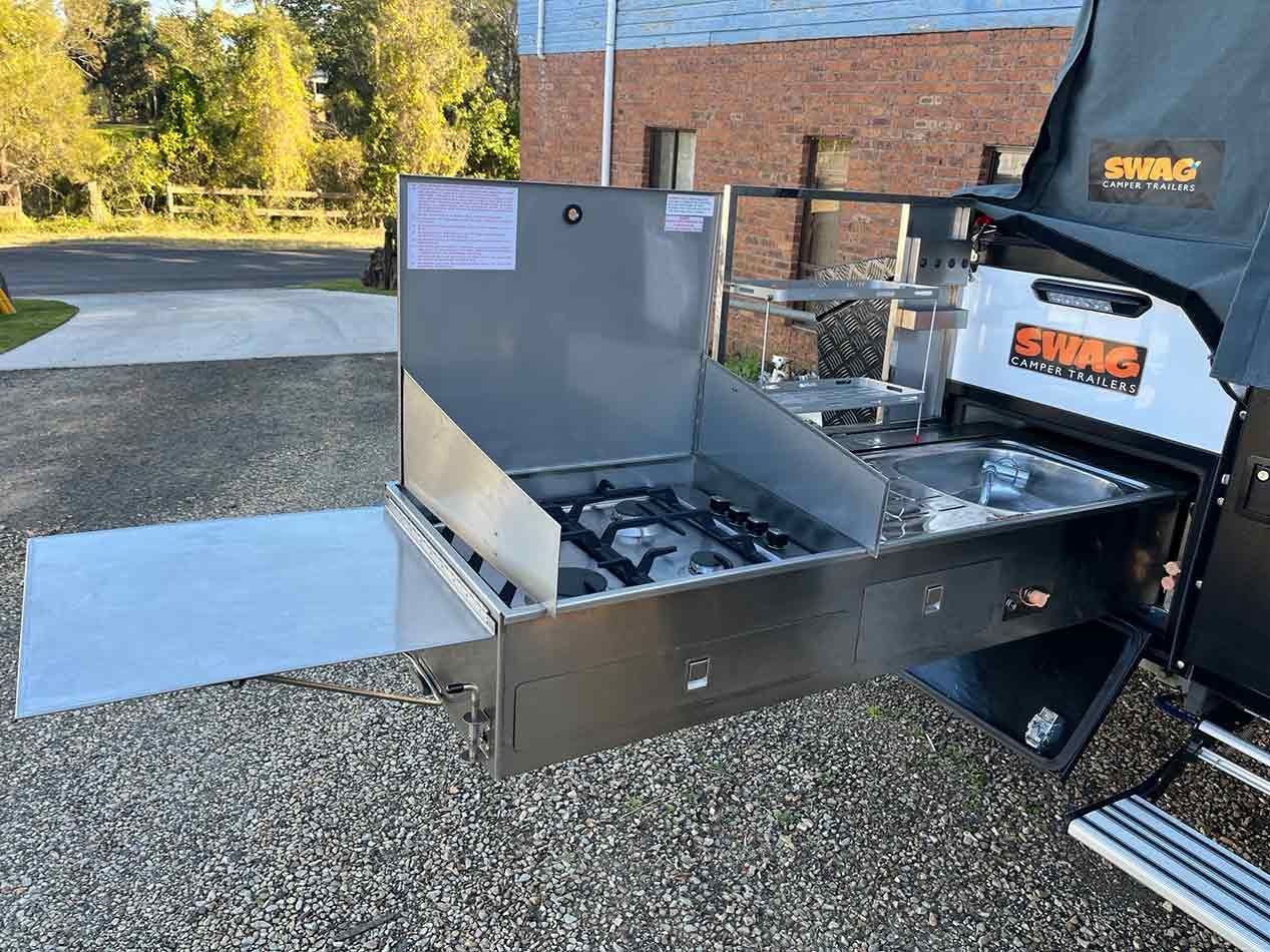 A Stainless Steel Stove Is Sitting In The Back Of A Truck — Perkins Caravans in Ballina, NSW