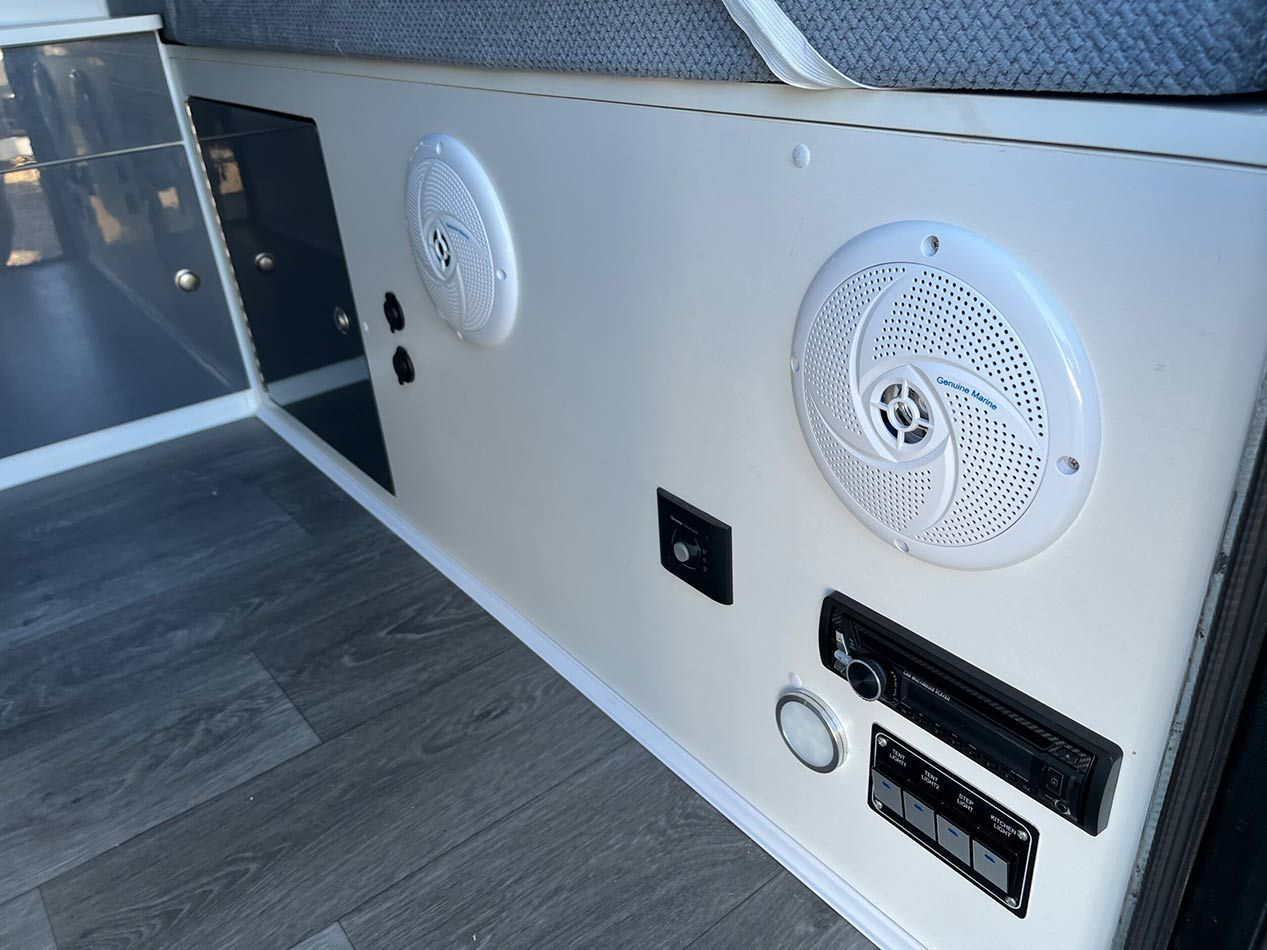 A White Wall With Speakers And A Radio On It — Perkins Caravans in Ballina, NSW