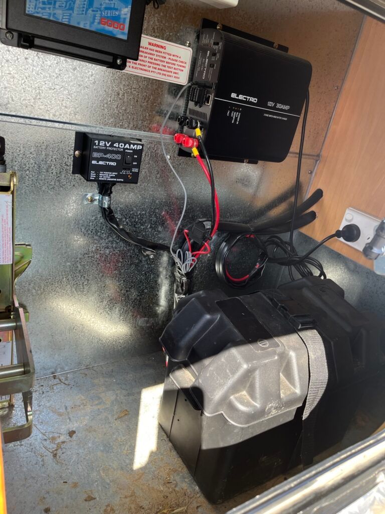 A Black Box With Wires Coming Out Of It Is Sitting On A Metal Surface — Perkins Caravans in Ballina, NSW