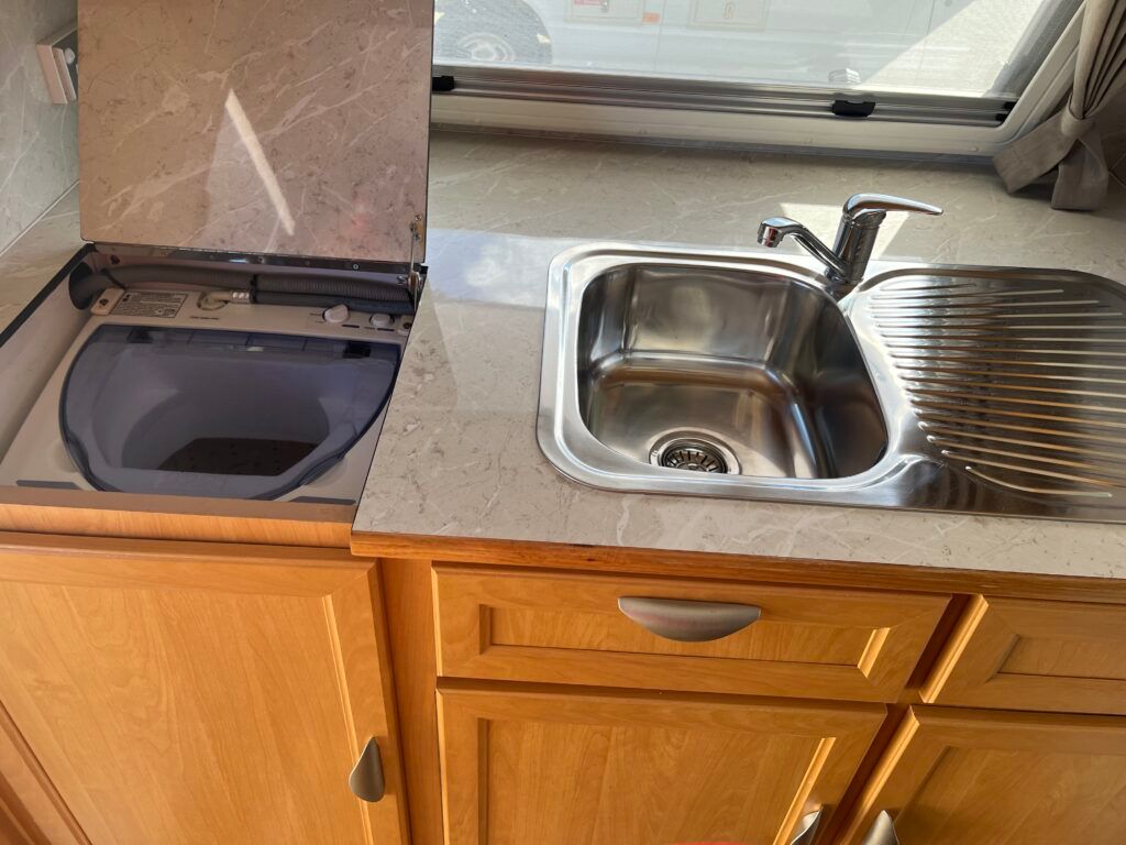 A Stainless Steel Sink Is Sitting On Top Of A Counter In A Kitchen — Perkins Caravans in Ballina, NSW