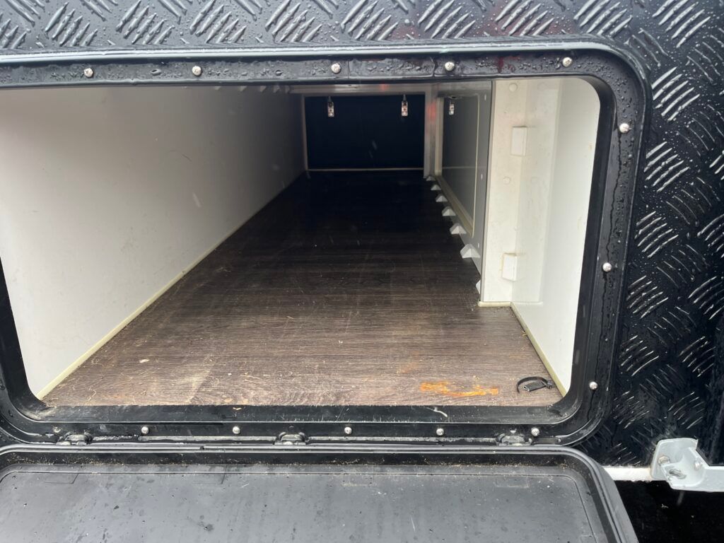 The Inside Of A Trailer With The Door Open And A Window — Perkins Caravans in Ballina, NSW