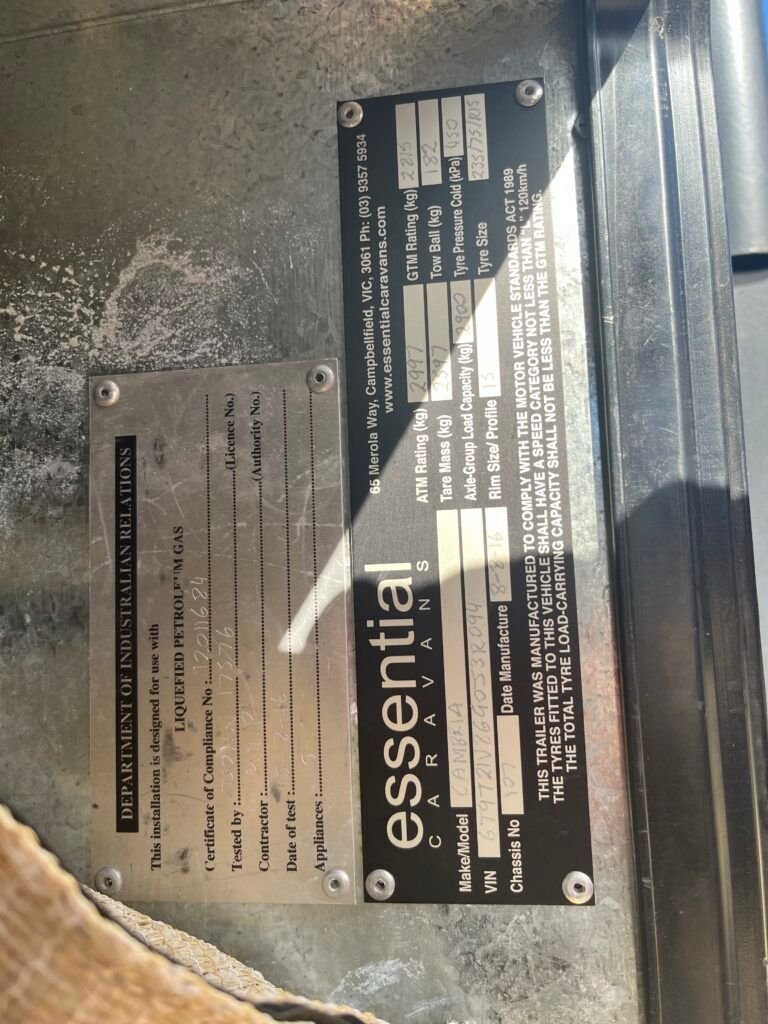 A Metal Plate With The Word Essential On It — Perkins Caravans in Ballina, NSW