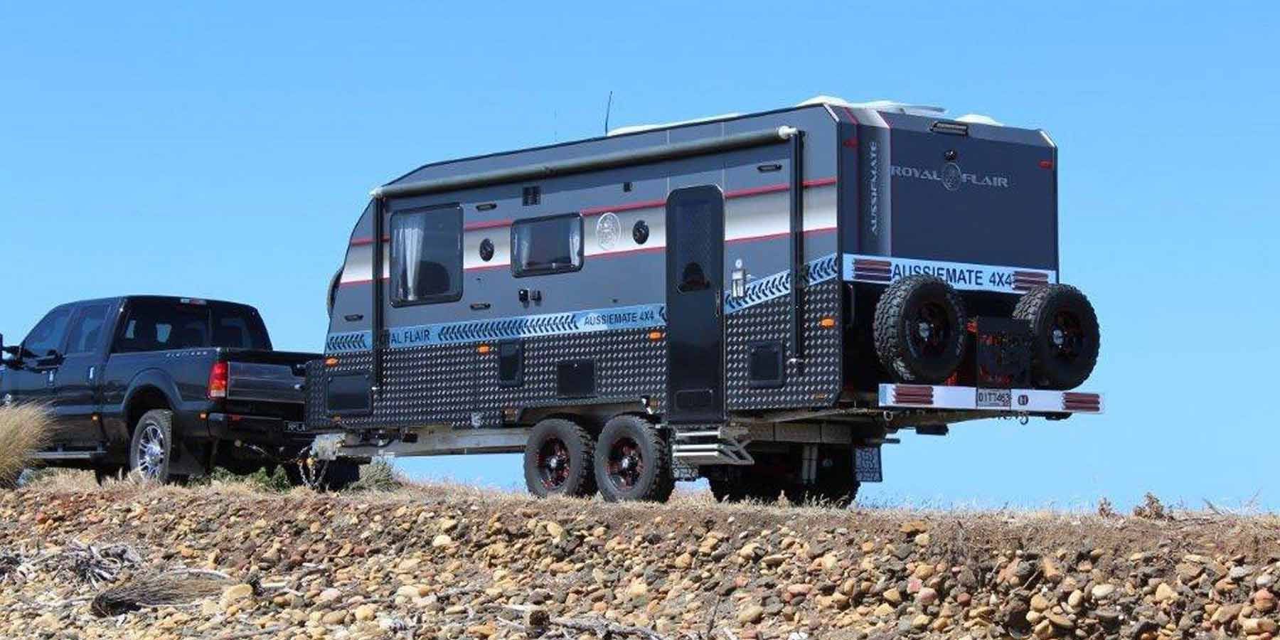 A Truck Is Towing A Trailer In The Desert — Perkins Caravans in Grafton, NSW