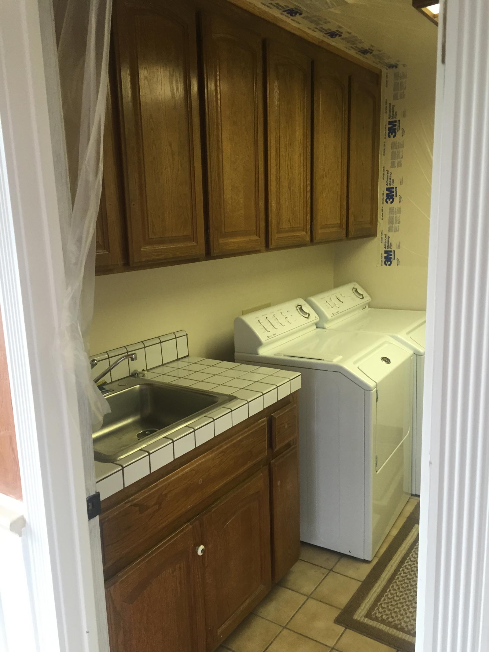 Before Laundry Cabinets Paint — Spokane, WA — TM Painting & Construction