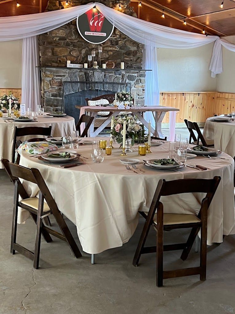 a room with tables and chairs set up for a wedding reception .