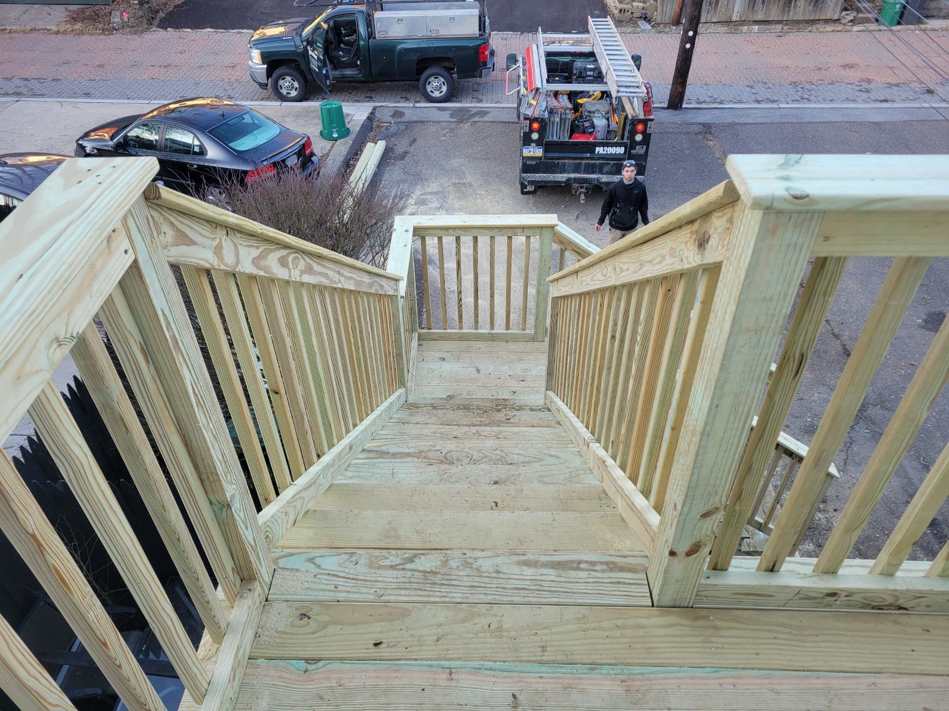 A wooden staircase with a truck parked behind it