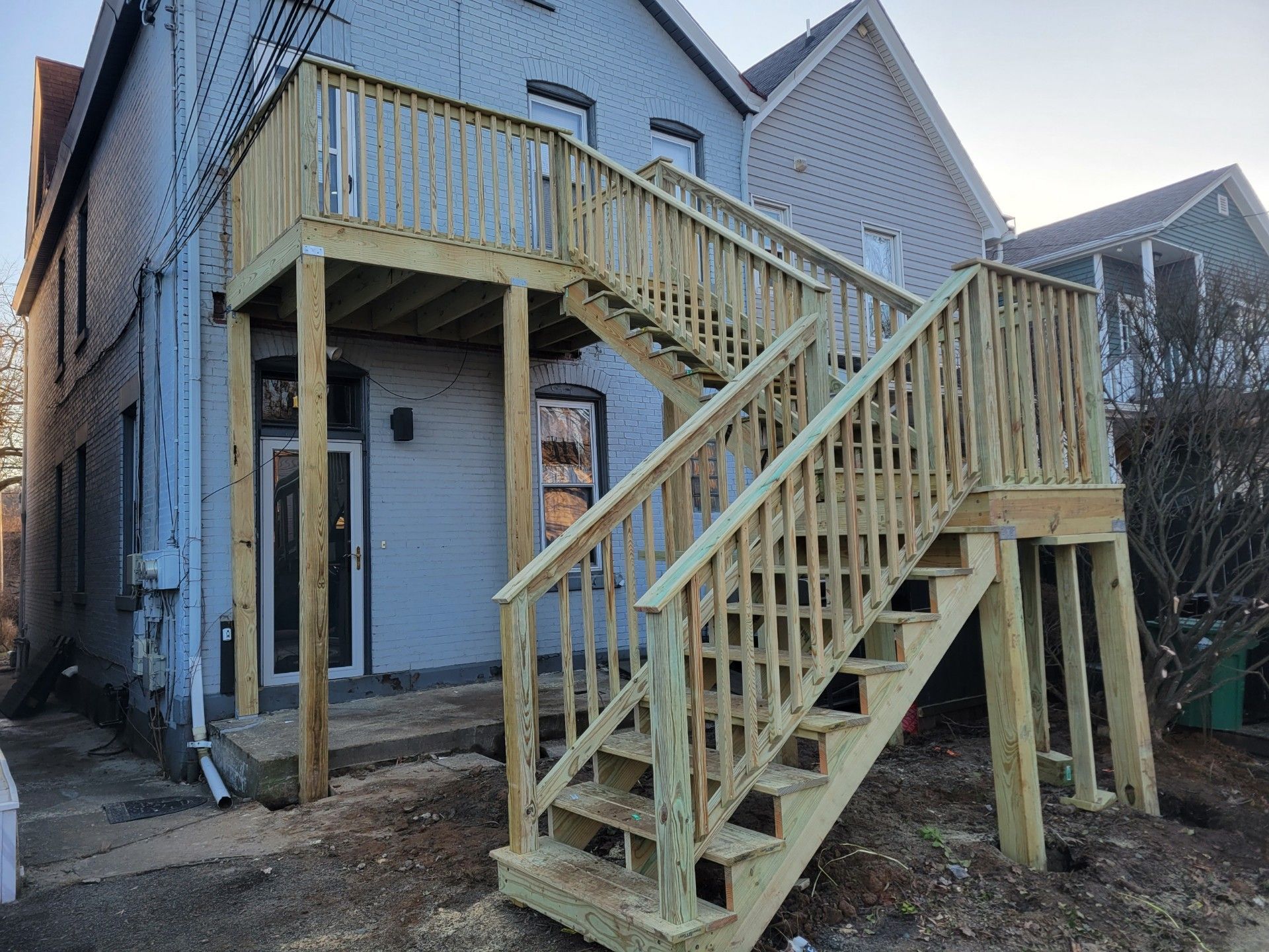 A wooden deck with stairs leading up to it