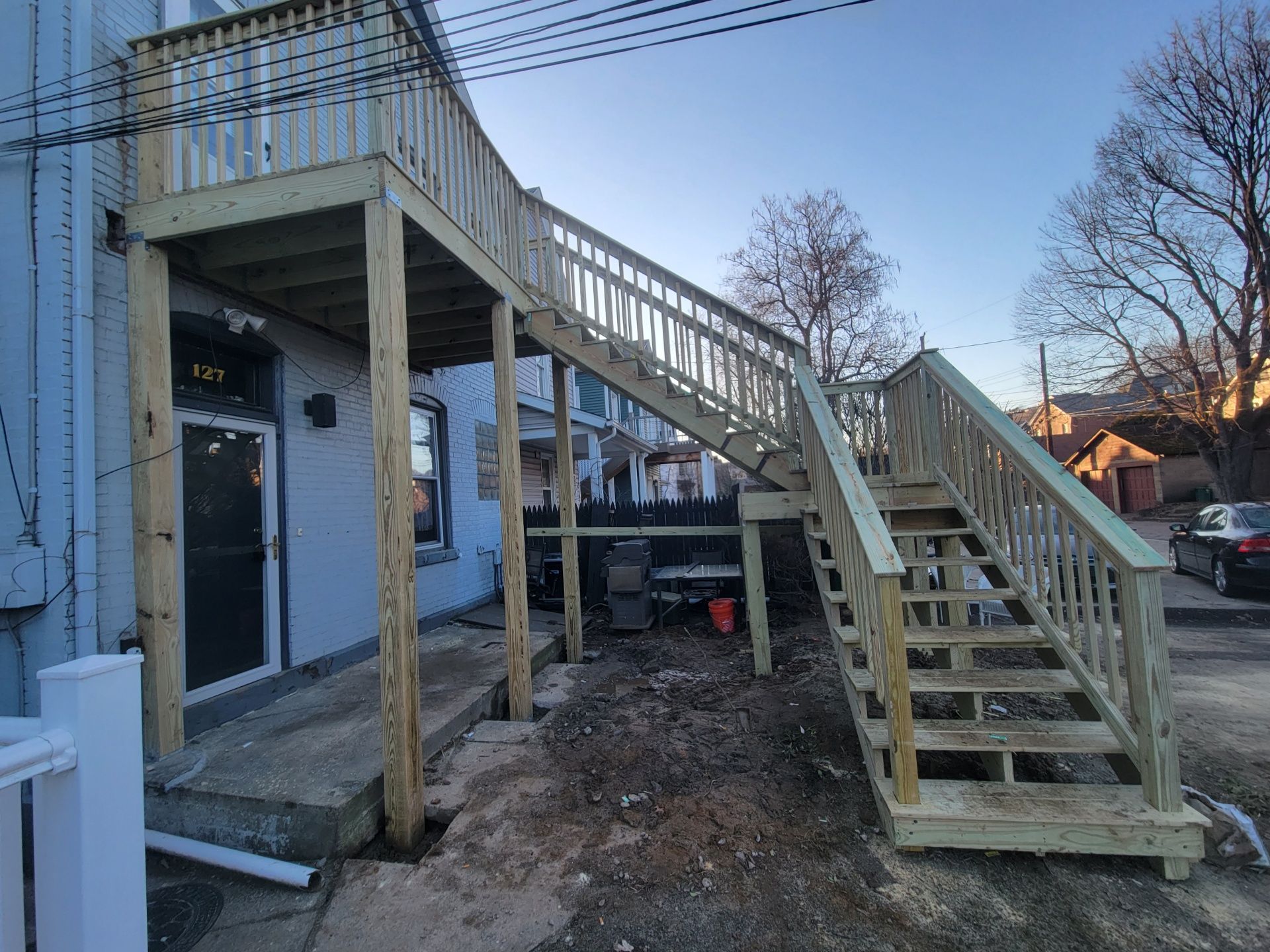 A wooden deck with stairs leading up to it