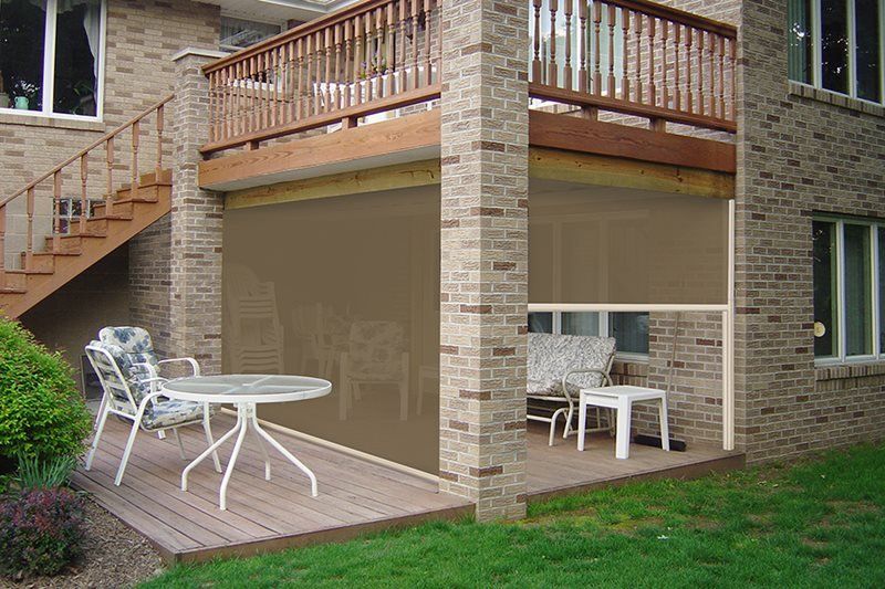 A brick house with a patio with a table and chairs