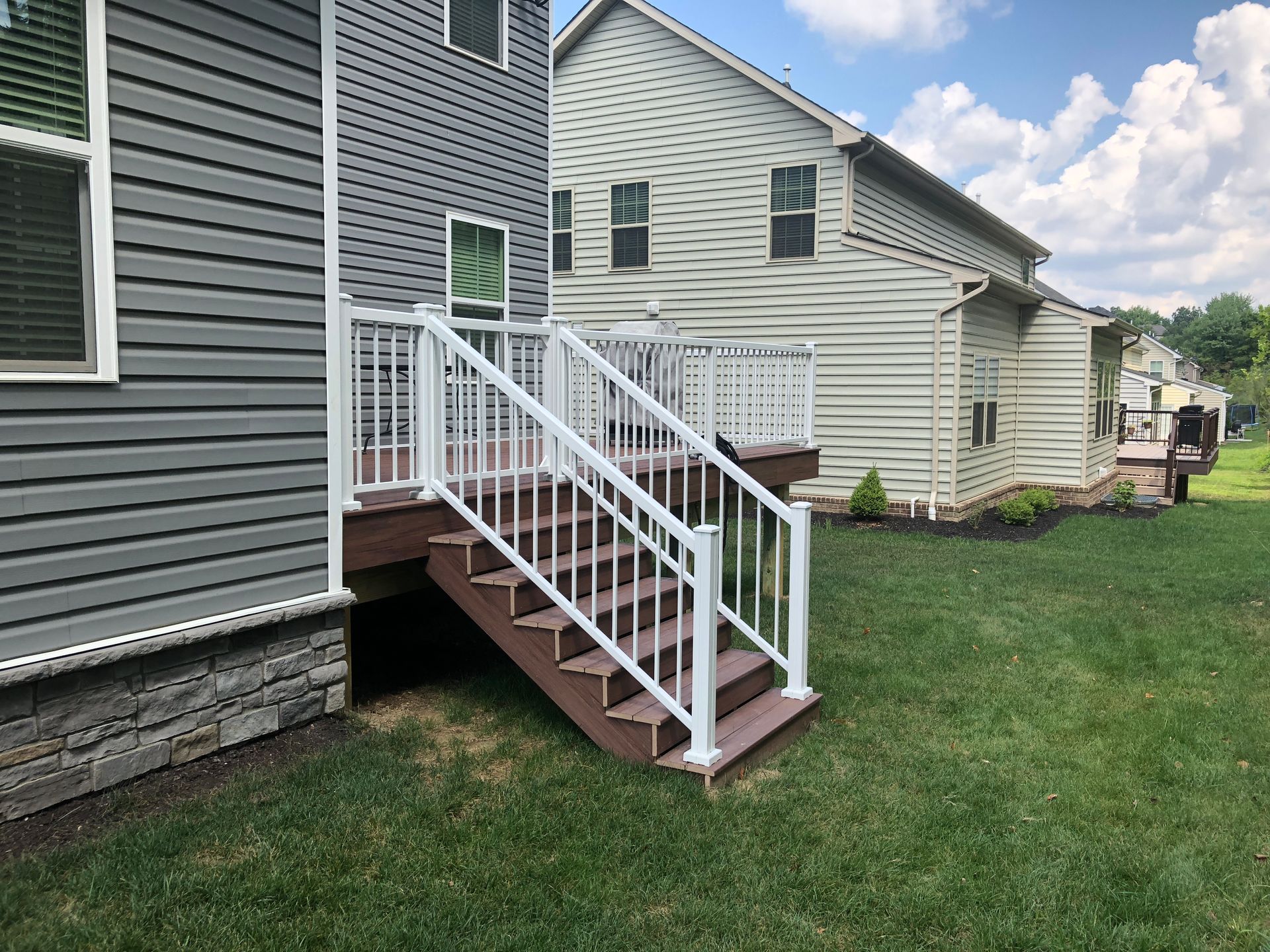 A house with a deck and stairs leading up to it